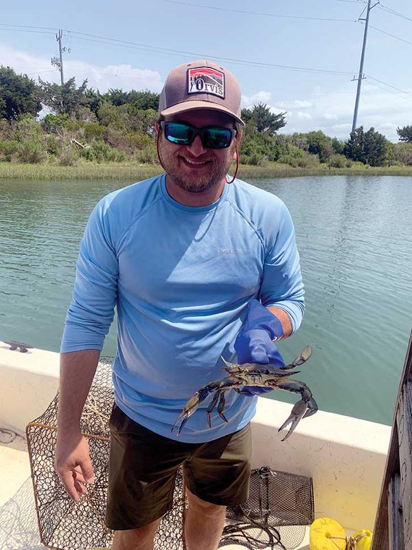 Alex Rocco holding blue crab.